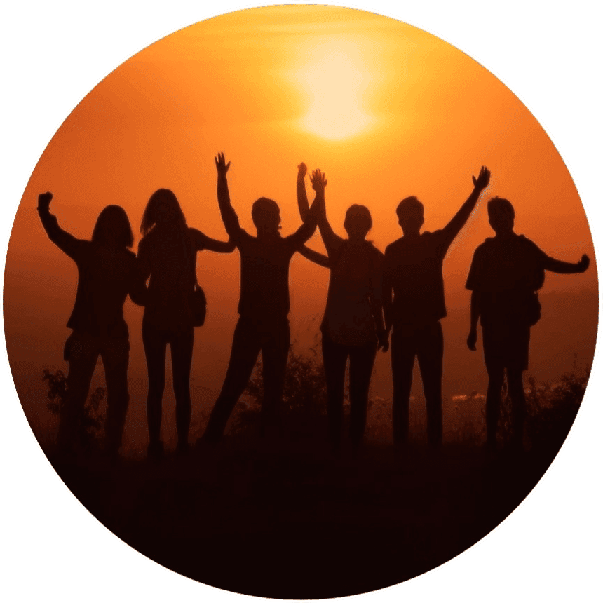 A group of people celebrating at sunset